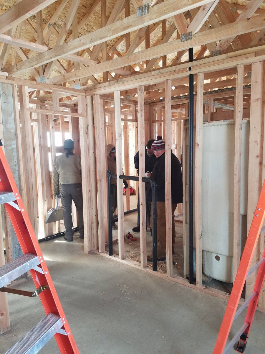 Plumbing students working on a Habitat for Humanity house in Granger