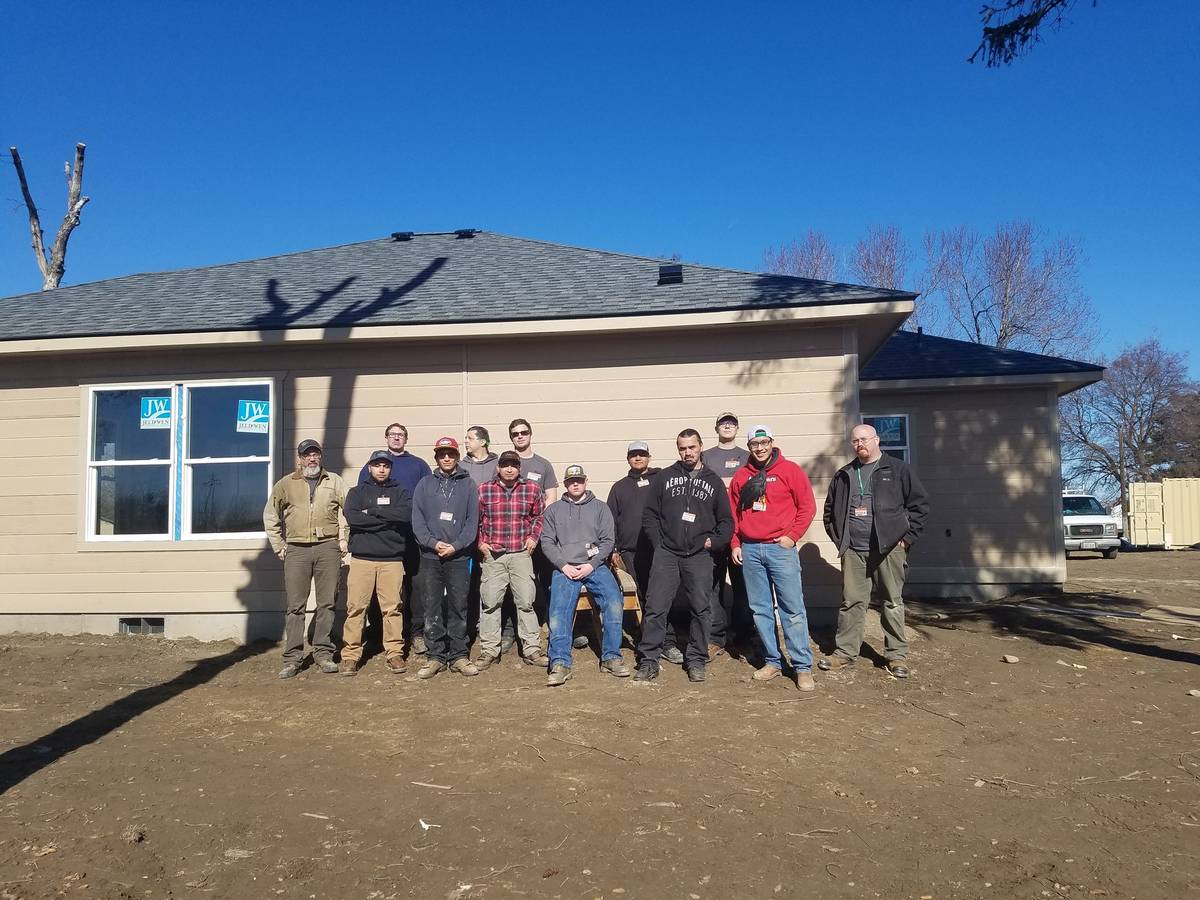 Plumbing students working on a Habitat for Humanity house in Granger