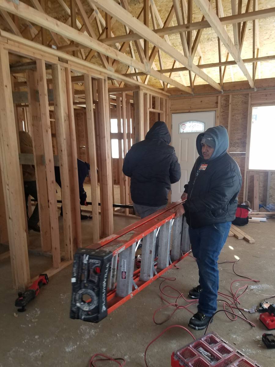 Plumbing students working on a Habitat for Humanity house in Granger